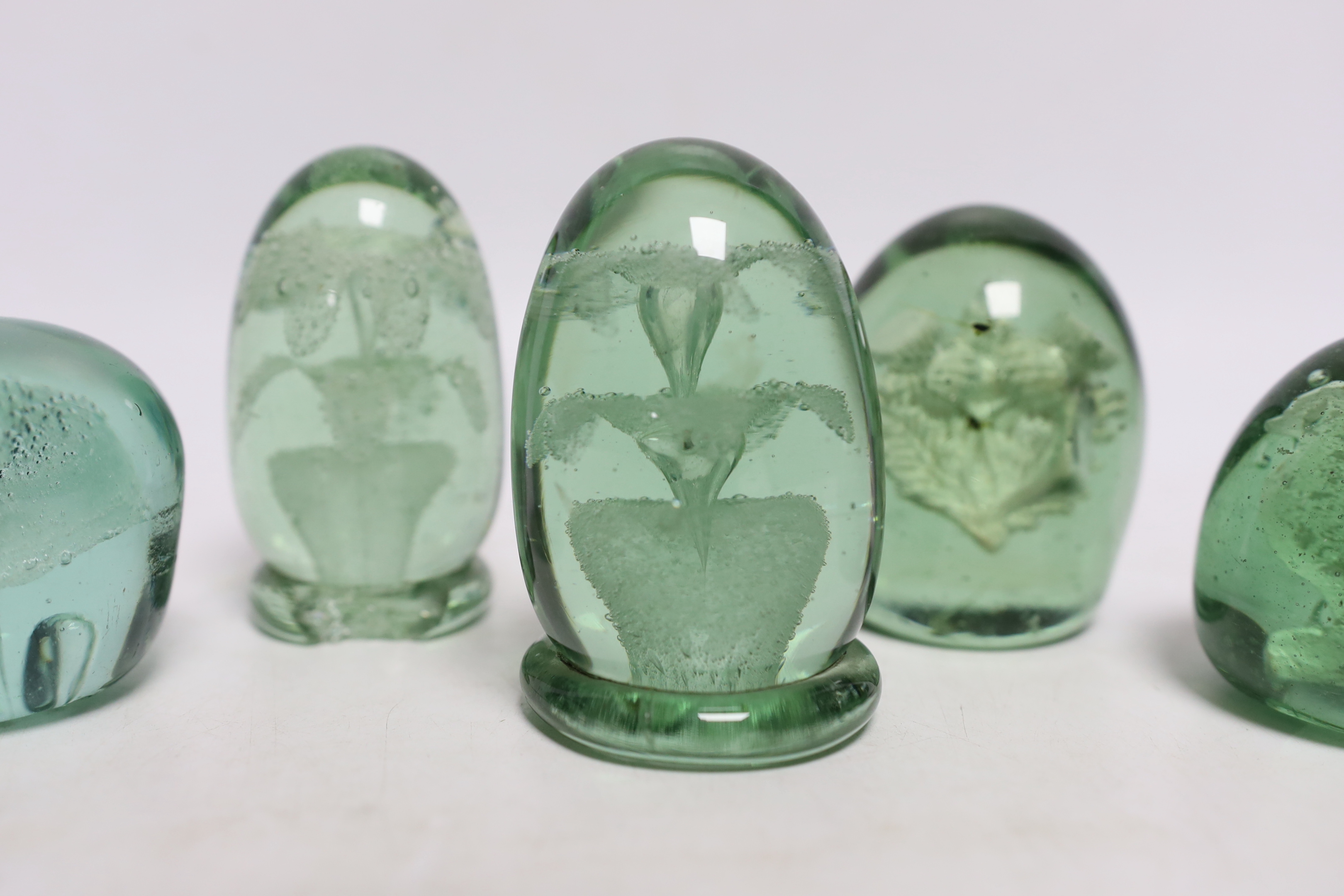 Five green glass dumps, including two with inset sulphides, tallest 9cm